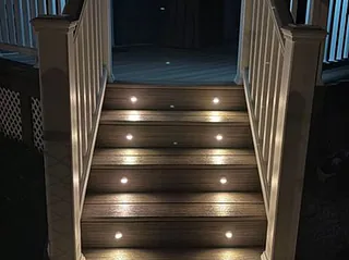 Lights in a staircase leading up to a deck