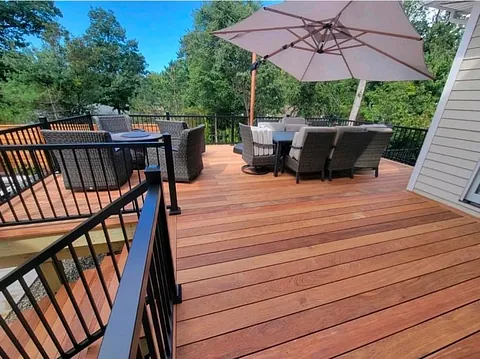 Warm wooden decking with outdoor chairs and a large umbrella